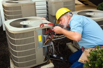 HVAC professional checking air conditioning unit